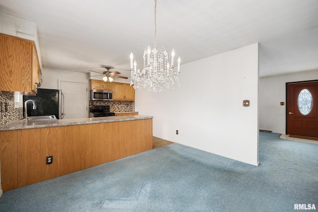 kitchen featuring refrigerator, hanging light fixtures, kitchen peninsula, black range with electric cooktop, and backsplash