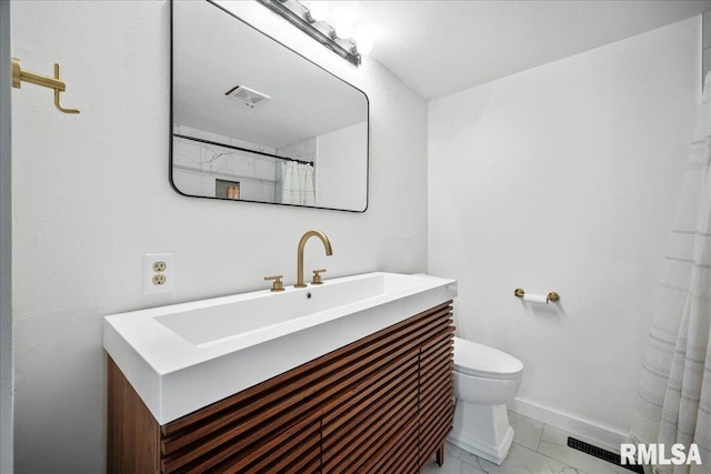 bathroom featuring vanity and toilet