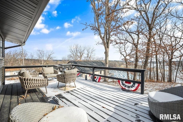 snow covered deck with an outdoor living space