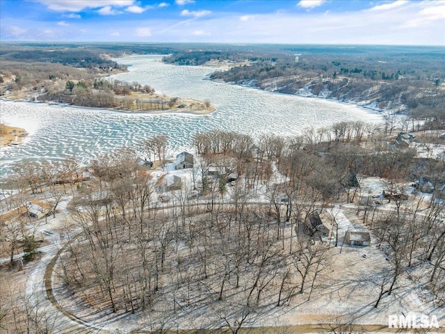 snowy aerial view with a water view