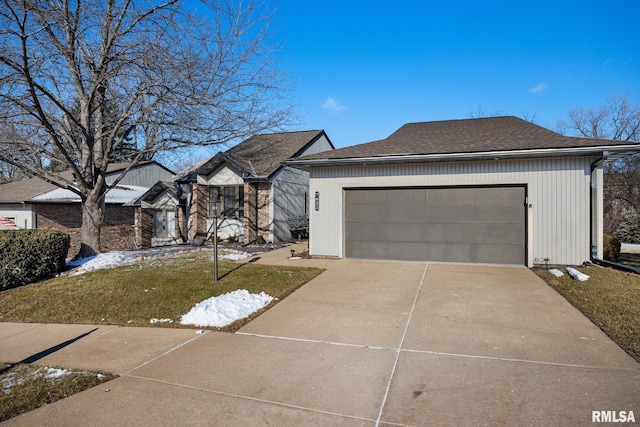 view of front of home featuring a garage and a front yard