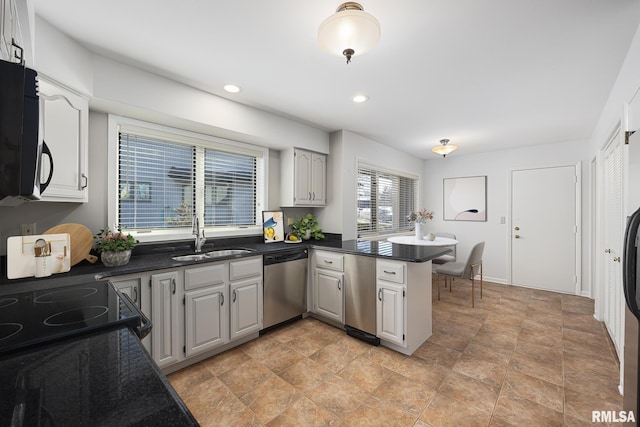 kitchen with sink, gray cabinets, kitchen peninsula, and dishwasher