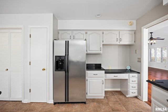 kitchen with white cabinetry, ceiling fan, and stainless steel fridge