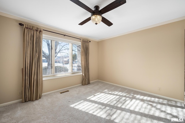 carpeted spare room with ornamental molding and ceiling fan