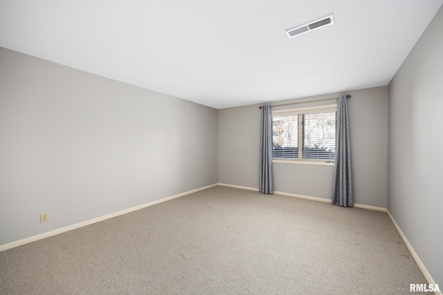 unfurnished room featuring light colored carpet