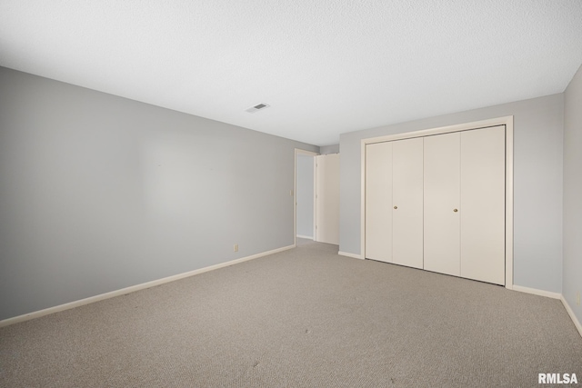 unfurnished bedroom with carpet and a closet