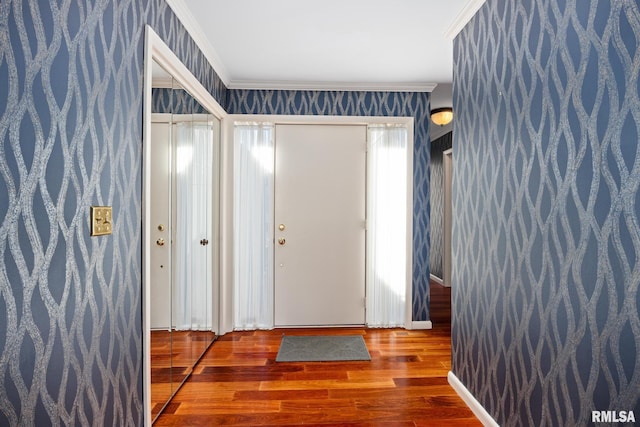 entrance foyer featuring crown molding and hardwood / wood-style flooring