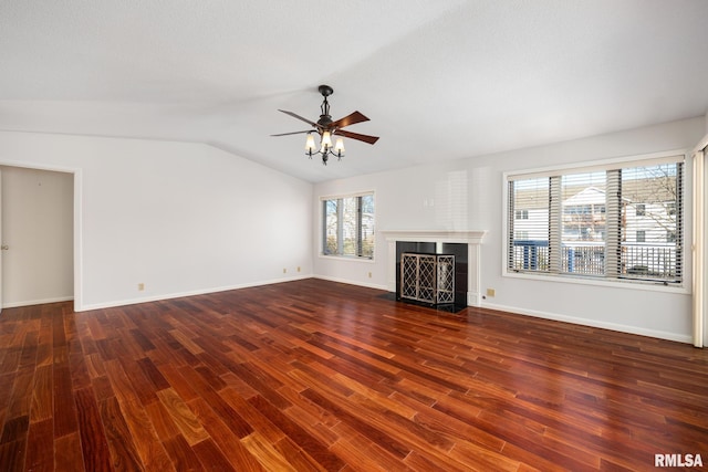 unfurnished living room with vaulted ceiling, dark hardwood / wood-style floors, and ceiling fan