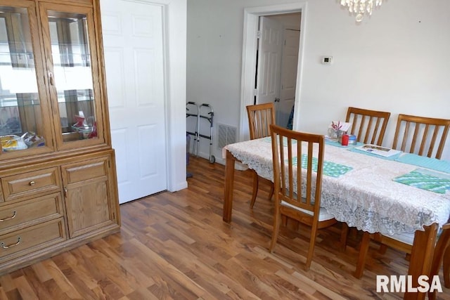 dining room featuring an inviting chandelier and hardwood / wood-style floors