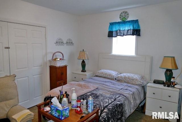 bedroom with dark carpet and a closet