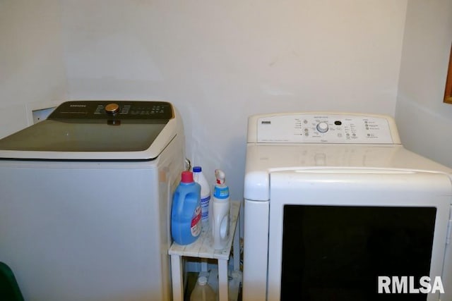 clothes washing area with washing machine and clothes dryer