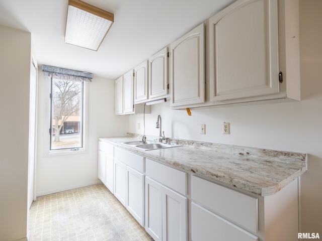 kitchen with sink and white cabinets