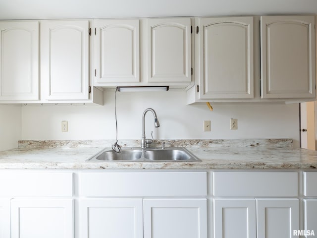 kitchen with white cabinetry and sink