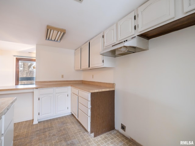 kitchen featuring white cabinets