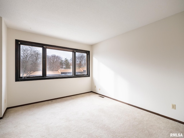 empty room with light colored carpet