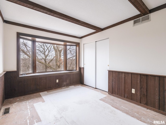 empty room featuring wooden walls