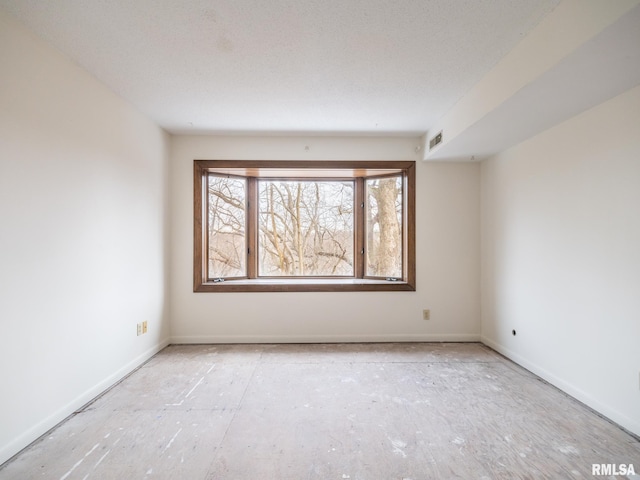 spare room with a textured ceiling