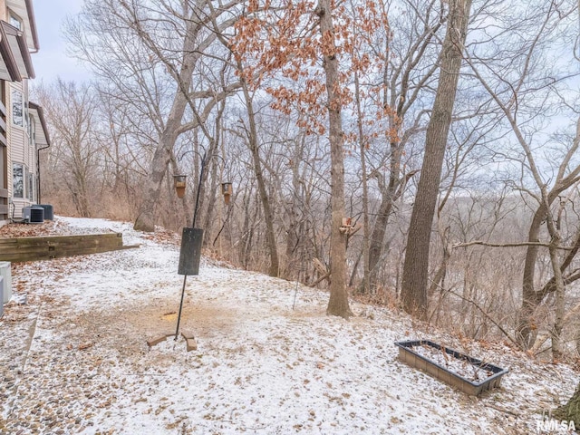 yard layered in snow featuring central AC