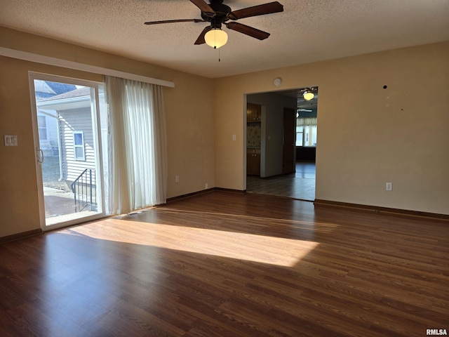 spare room featuring ceiling fan, dark wood-type flooring, and a textured ceiling