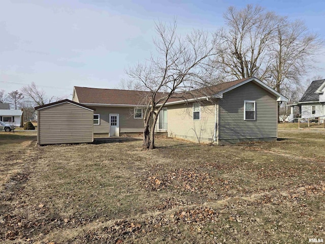 rear view of house featuring a yard