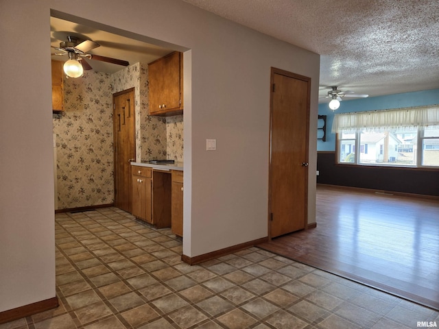 kitchen with a textured ceiling and ceiling fan