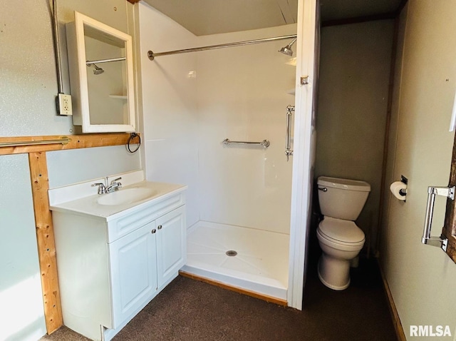 bathroom with walk in shower, vanity, and toilet