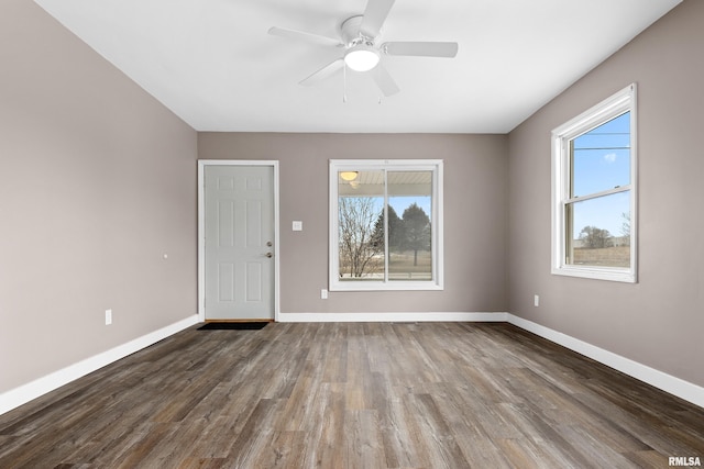 spare room featuring dark hardwood / wood-style floors and ceiling fan