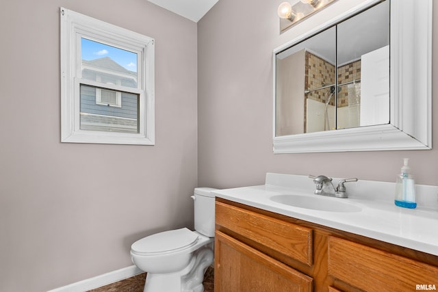 bathroom with vanity, a shower, and toilet