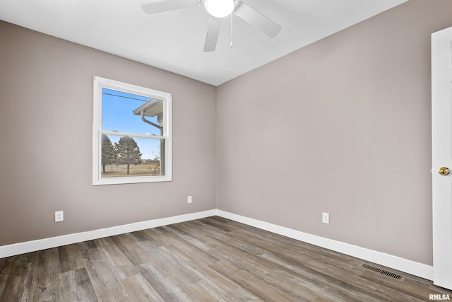 empty room with ceiling fan and hardwood / wood-style floors