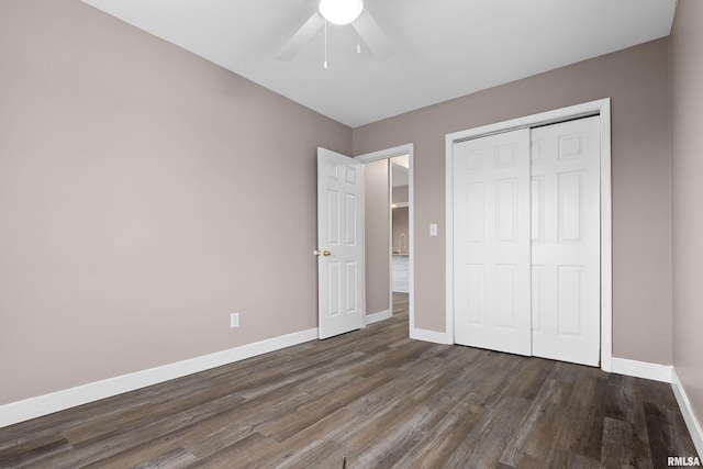 unfurnished bedroom featuring dark hardwood / wood-style floors, a closet, and ceiling fan