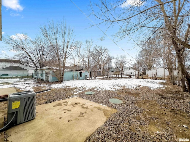 yard covered in snow featuring central air condition unit