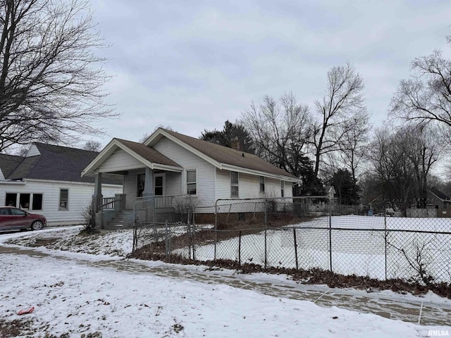 view of snow covered exterior featuring covered porch