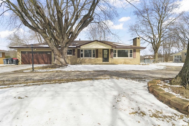 view of front of house featuring a chimney and an attached garage