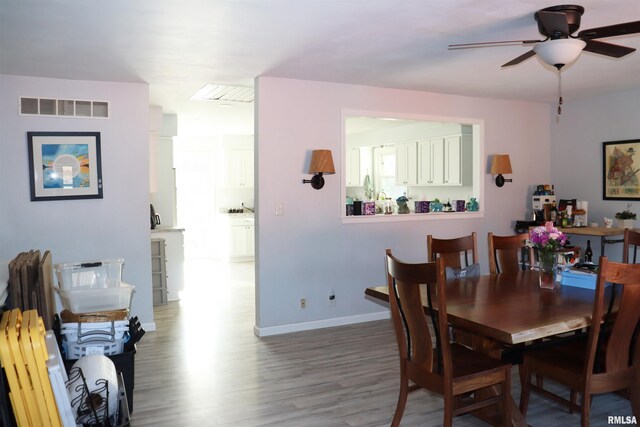 dining space featuring hardwood / wood-style floors and ceiling fan