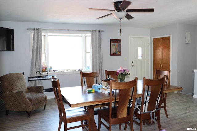 dining area with hardwood / wood-style flooring and ceiling fan