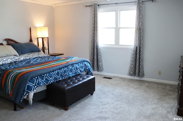 bedroom with crown molding and carpet floors