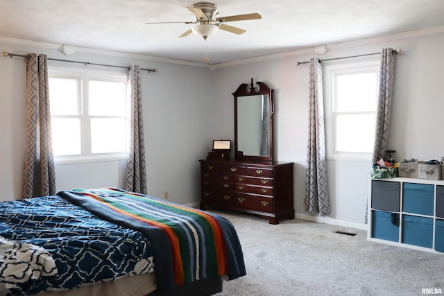 bedroom featuring ornamental molding, light colored carpet, and ceiling fan