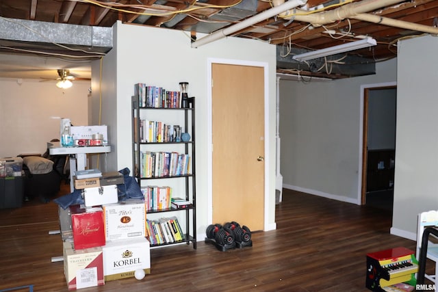 basement featuring dark hardwood / wood-style flooring and ceiling fan