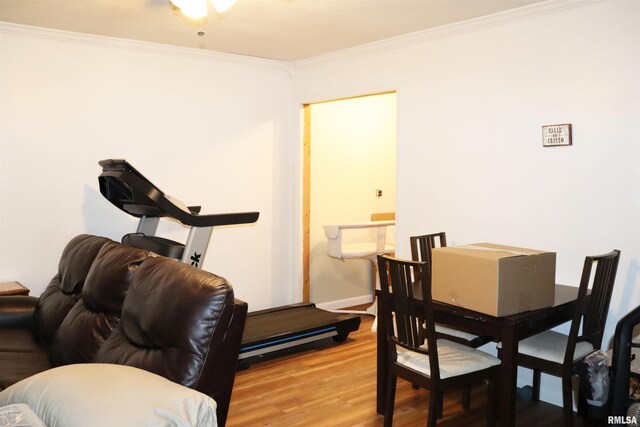 dining area with crown molding and wood-type flooring