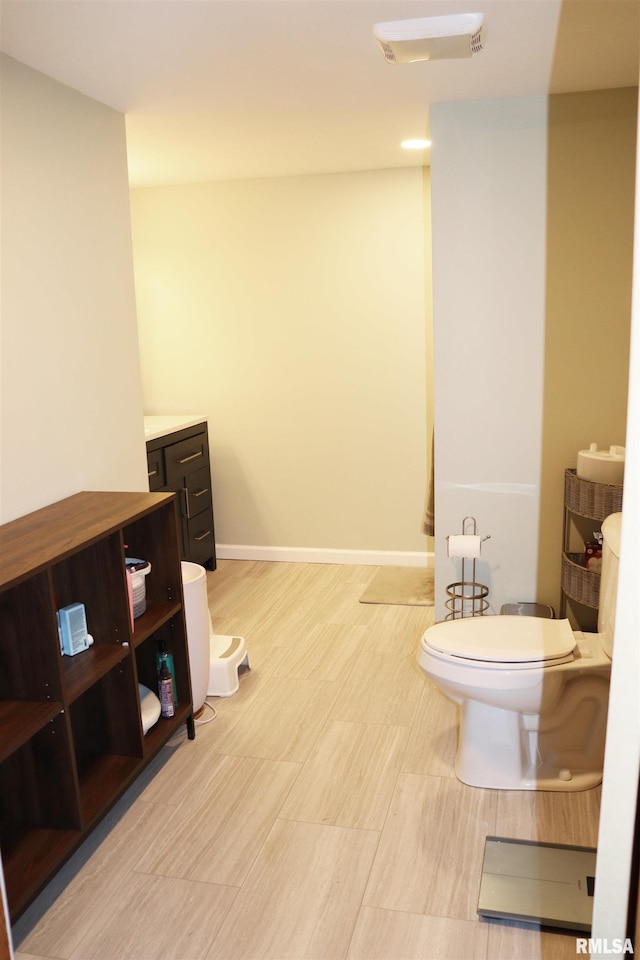 bathroom with toilet and vanity