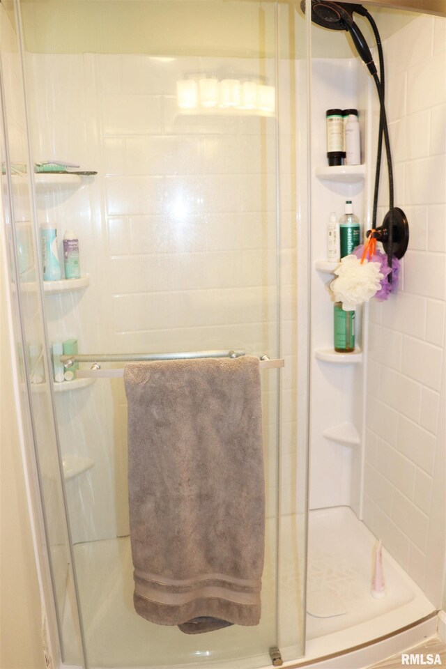 bathroom with a shower with door