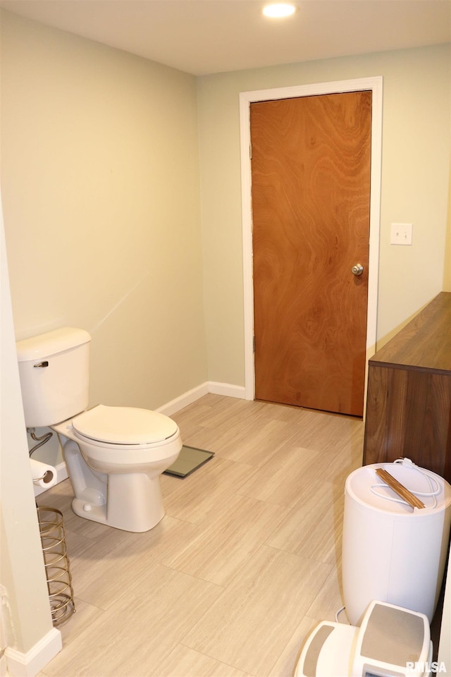 bathroom with wood-type flooring and toilet