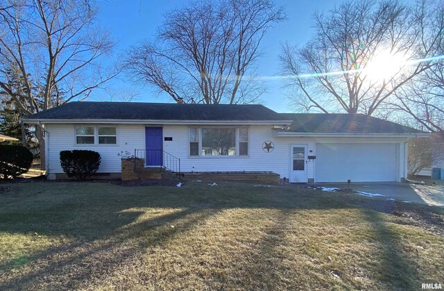 ranch-style home with a garage and a front yard