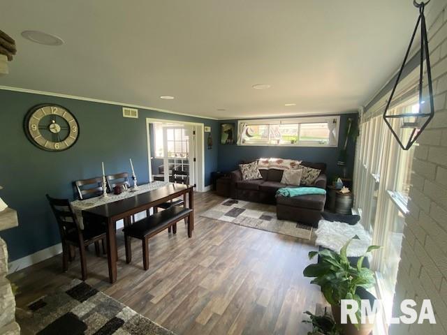 dining area with hardwood / wood-style floors and crown molding