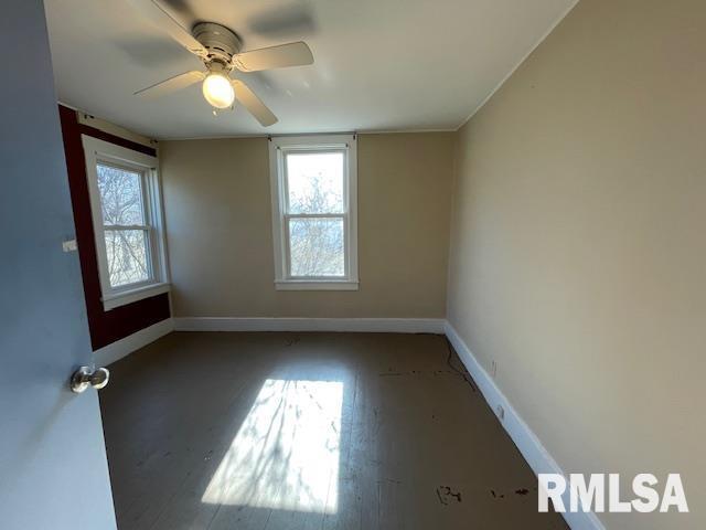 empty room featuring hardwood / wood-style flooring and ceiling fan