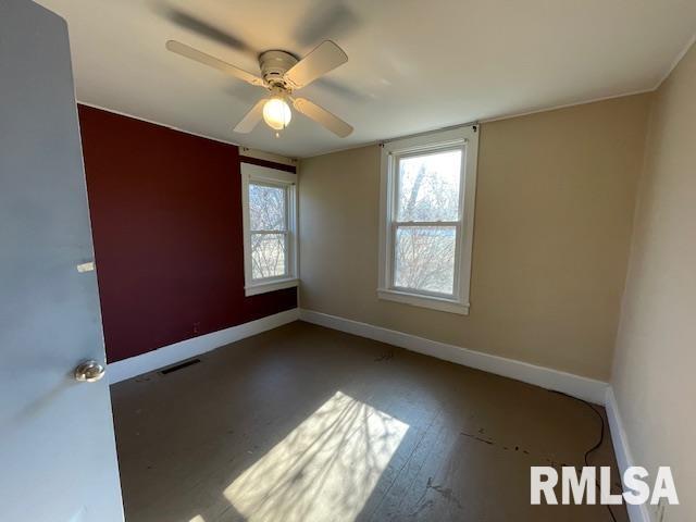 unfurnished room featuring hardwood / wood-style flooring and ceiling fan