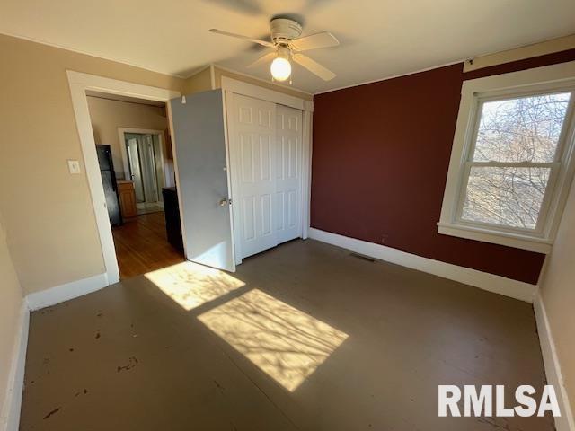 unfurnished bedroom with a closet and ceiling fan