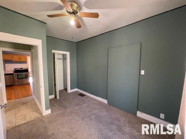 unfurnished bedroom featuring ceiling fan and light carpet