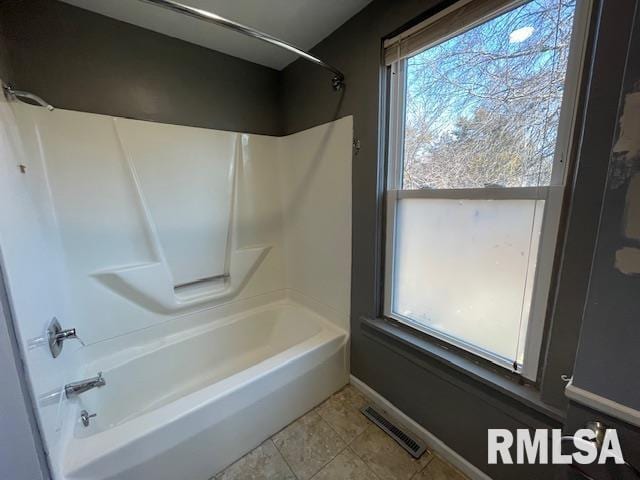 bathroom with tile patterned floors and  shower combination