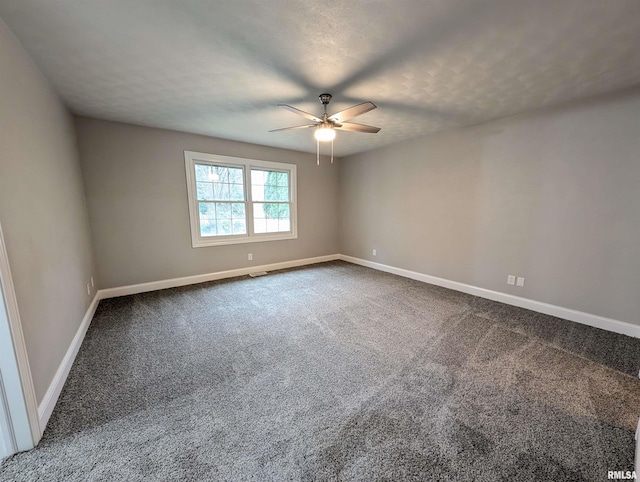 carpeted empty room featuring a ceiling fan, a textured ceiling, and baseboards